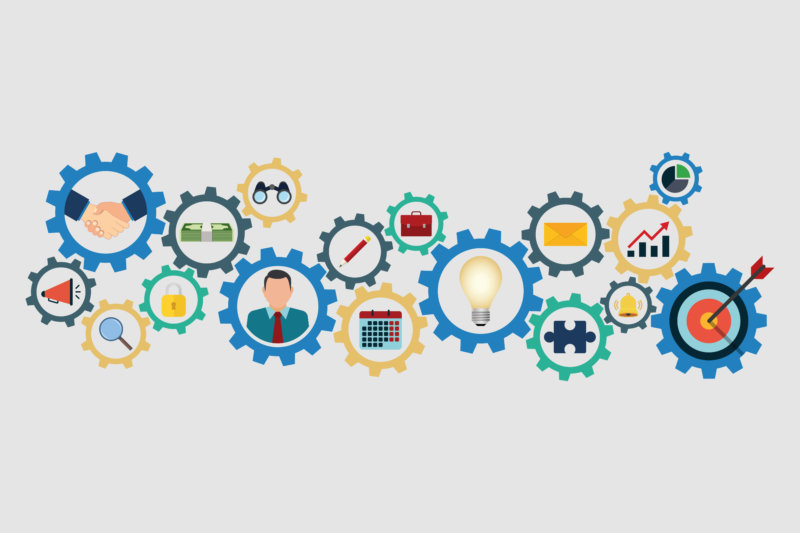 Various multi-colored cogs representing different aspects of a business including HR, sales, and marketing