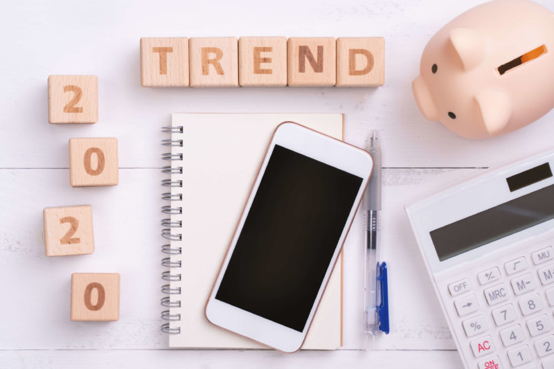 2020 VoIP trends image of blocks that spell out 2020 Trend with a mobile phone, note pad, pen, calculator, and piggy bank
