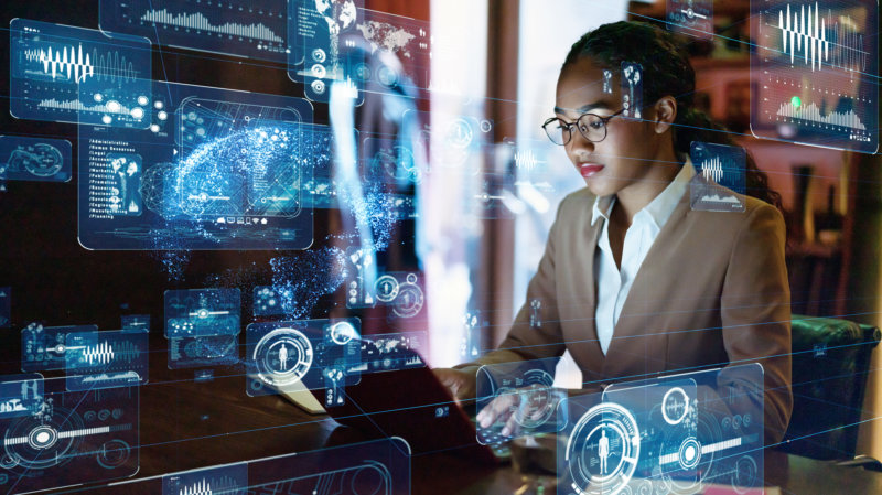 Young woman engineer with dreadlocks with a GUI overlaying her picture for an augmented analytics concept, business intelligence